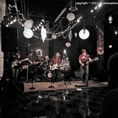 Darren &#34;Danger&#34; Boaz (center) of Lo Pan&#39;s Revenge joins the house band for &#34;Run, Run, Rudolph&#34;