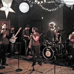 Tiffany Burtin (center) is joined by her husband and Jeff Burtin (right) on guitar, and Jacob Hodge (left) on vocals for &#34;Have Yourself A Merry Little Christmas&#34;