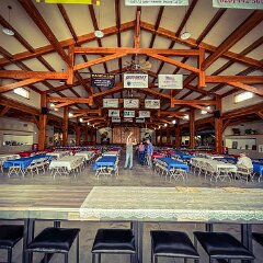 We had to set up early as there was a wedding that afternoon. This is the view from the wedding party table at the far end from the stage. PLEASE NOTICE the huge barn style doors on the stage now closed until they introduced us later that evening 😎