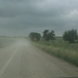 can barely see the tops of tents between the trees